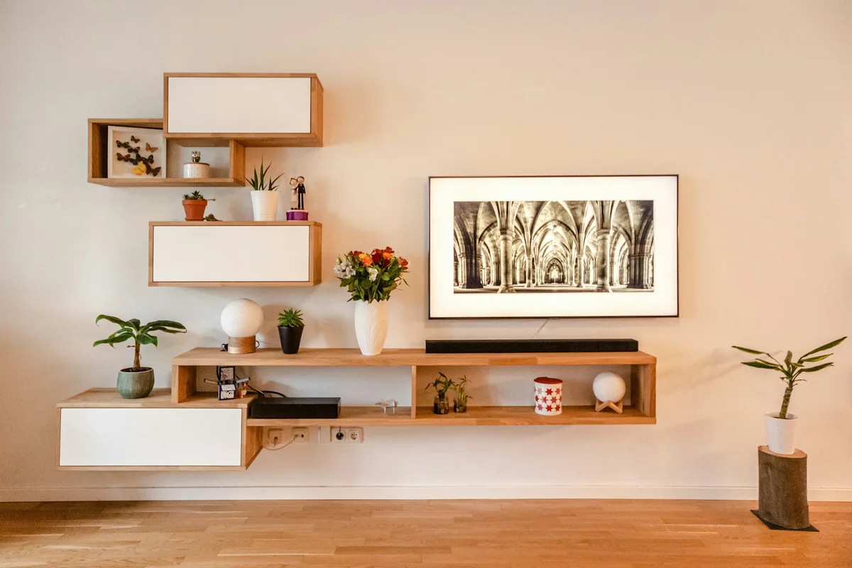 Timber and white wall-mounted cabinets and shelving with decorative objects